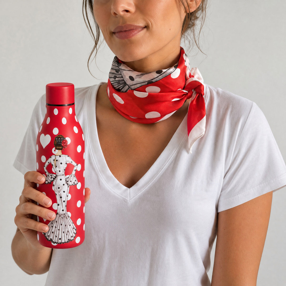 Pañuelo de seda flamenco María Blanco anudado al cuello y la botella térmica a juego