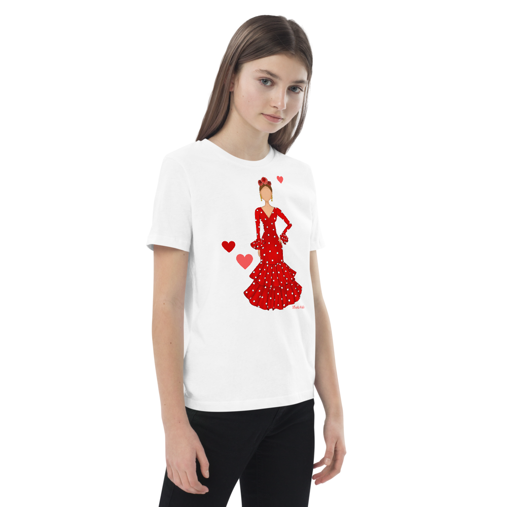 Camiseta flamenca de niñas de algodón 100% orgánico - Modelo Ana, camiseta decorada con un diseño flamenco, junto a un par de zapatos deportivos.