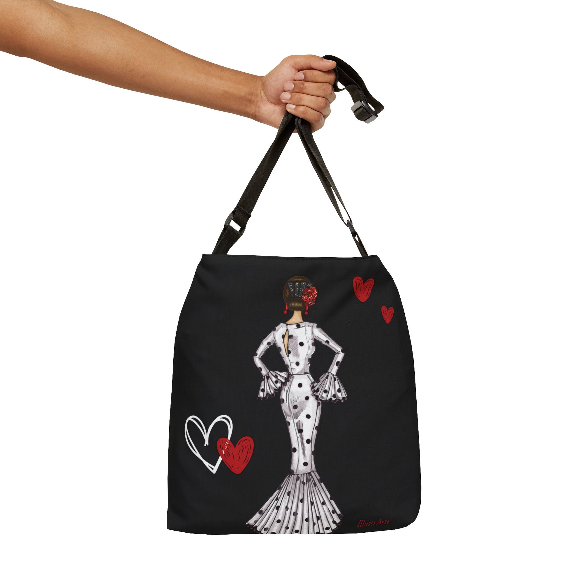 a hand holding a black bag with a lady in a dress on it