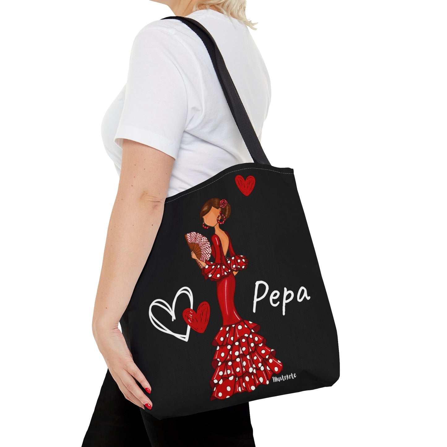 a woman carrying a black tote bag with a picture of a woman in a