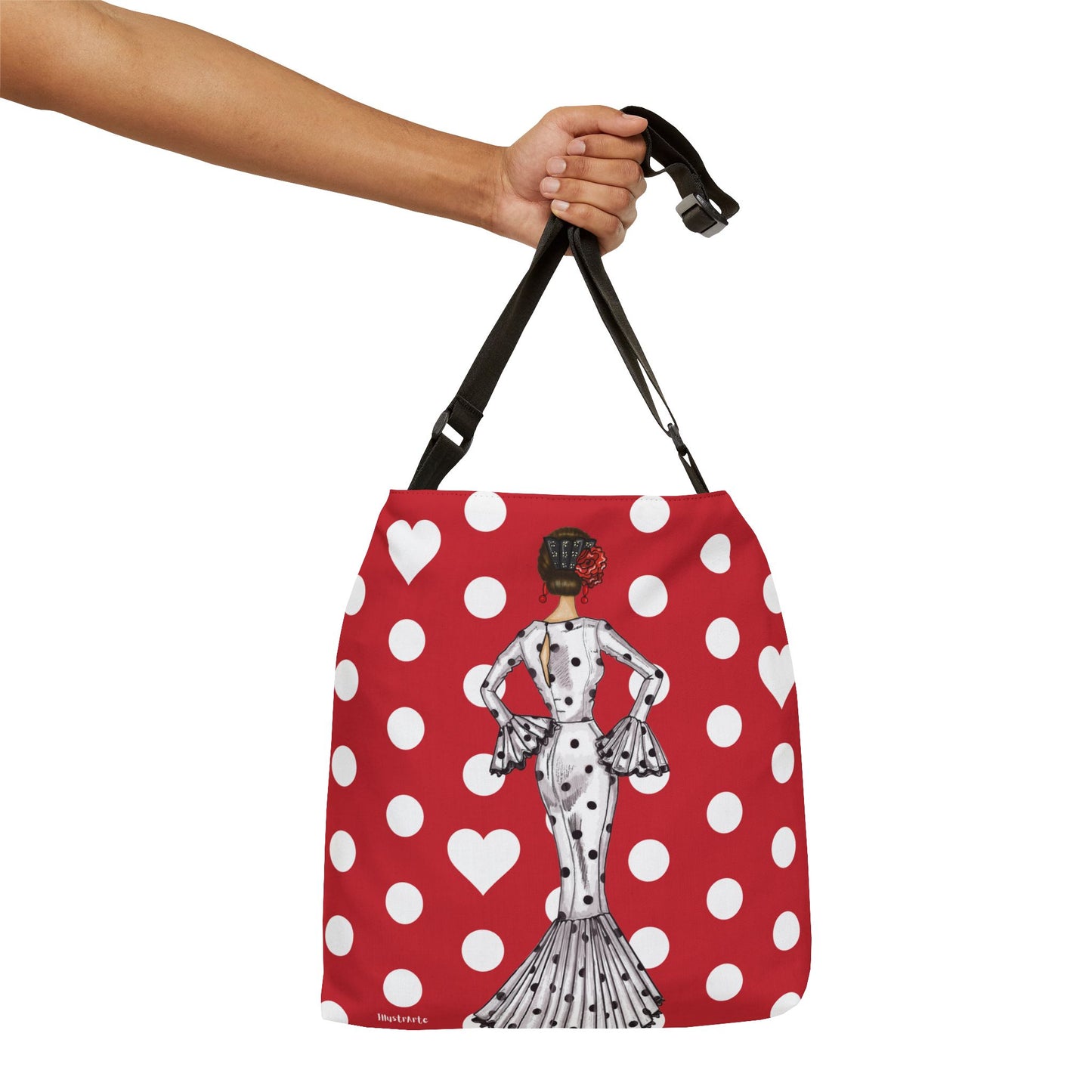 a hand holding a red and white polka dot purse