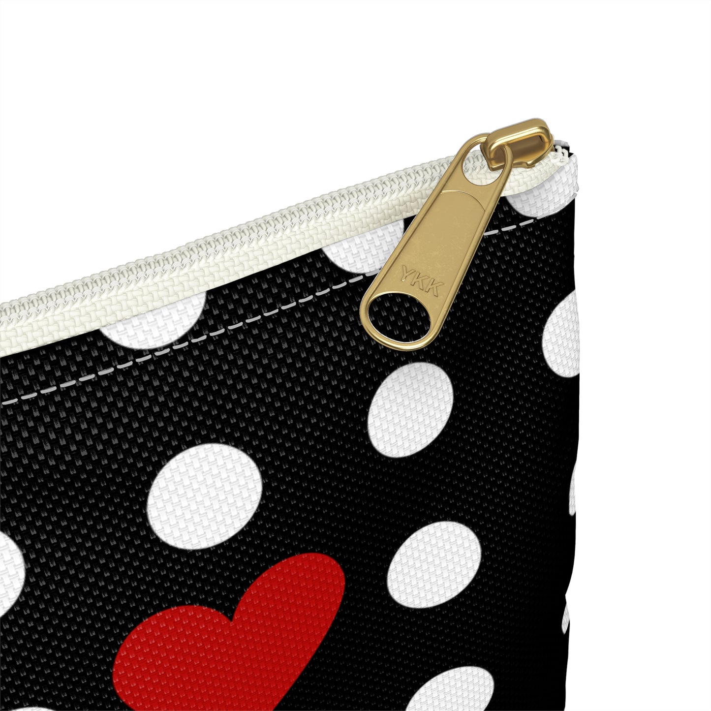 a black and white polka dot purse with a red heart on it