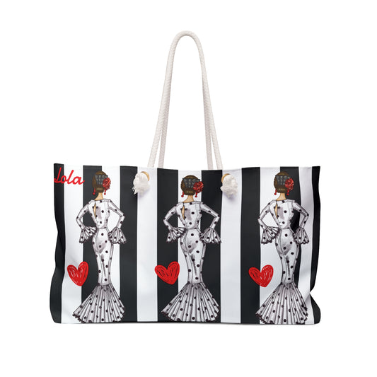 a black and white striped bag with a picture of a woman