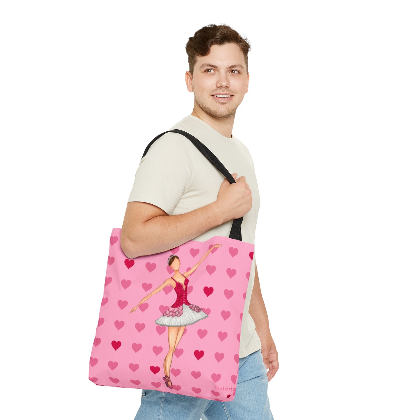 a man holding a pink bag with a ballerina on it