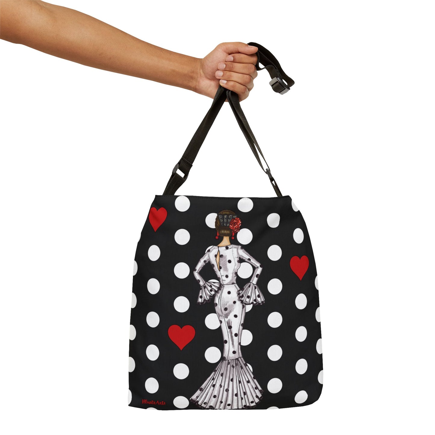 a hand holding a black and white polka dot purse