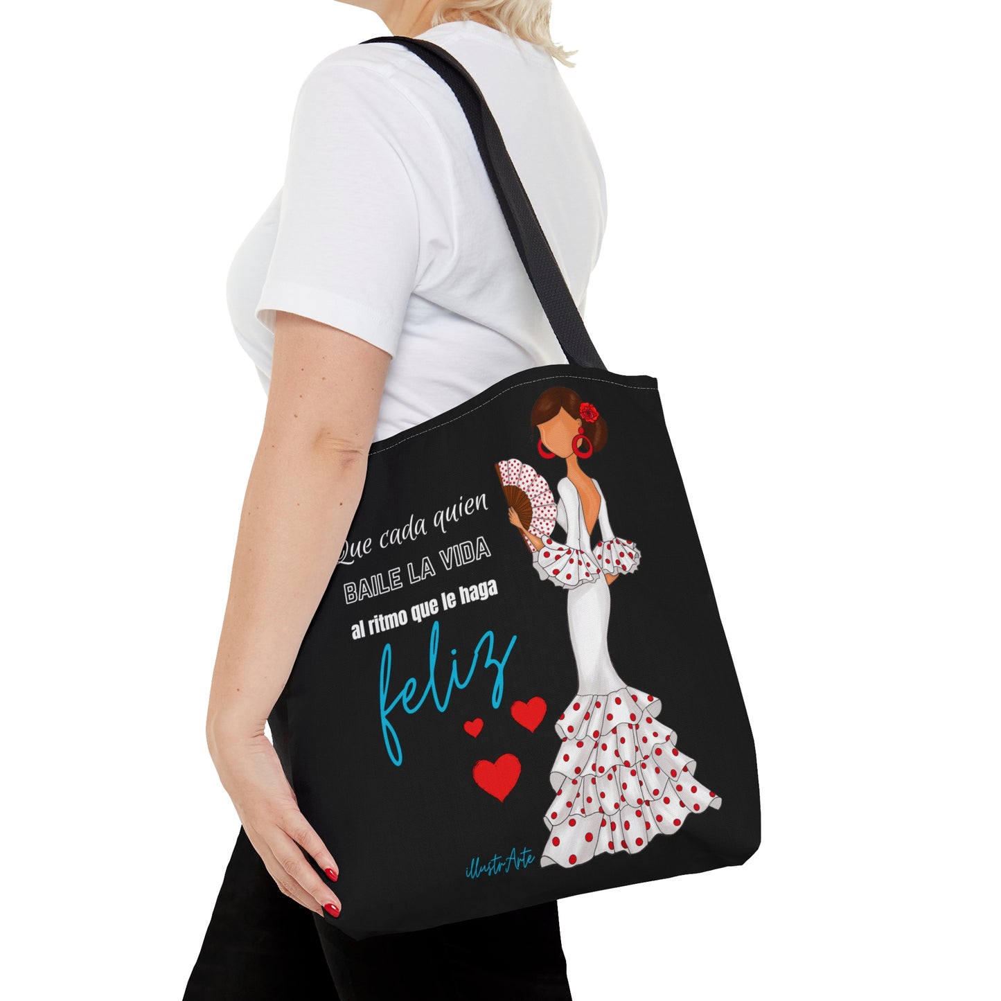 a woman carrying a black tote bag with a picture of a woman in a