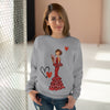 a woman wearing a sweater with a picture of a woman holding a heart