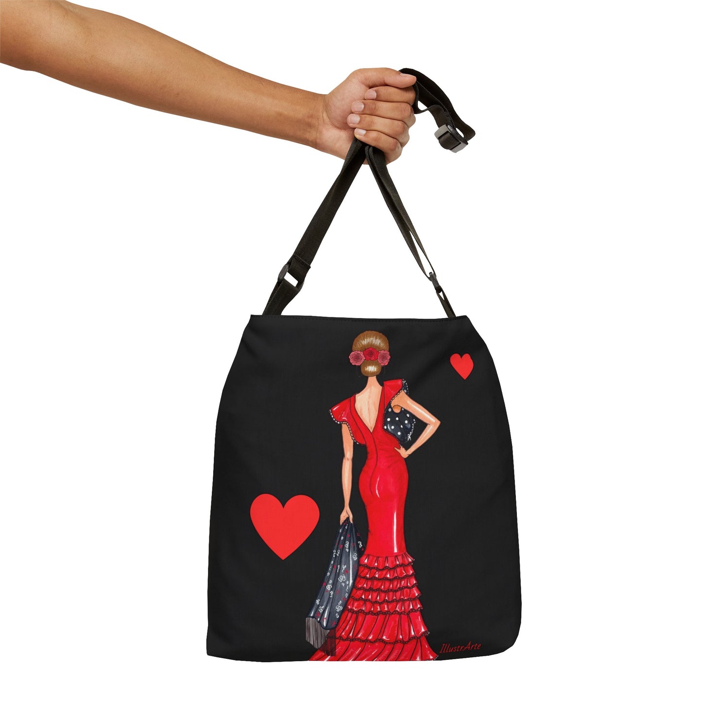 una mano sosteniendo una bolsa negra con una imagen de una mujer en un vestido rojo