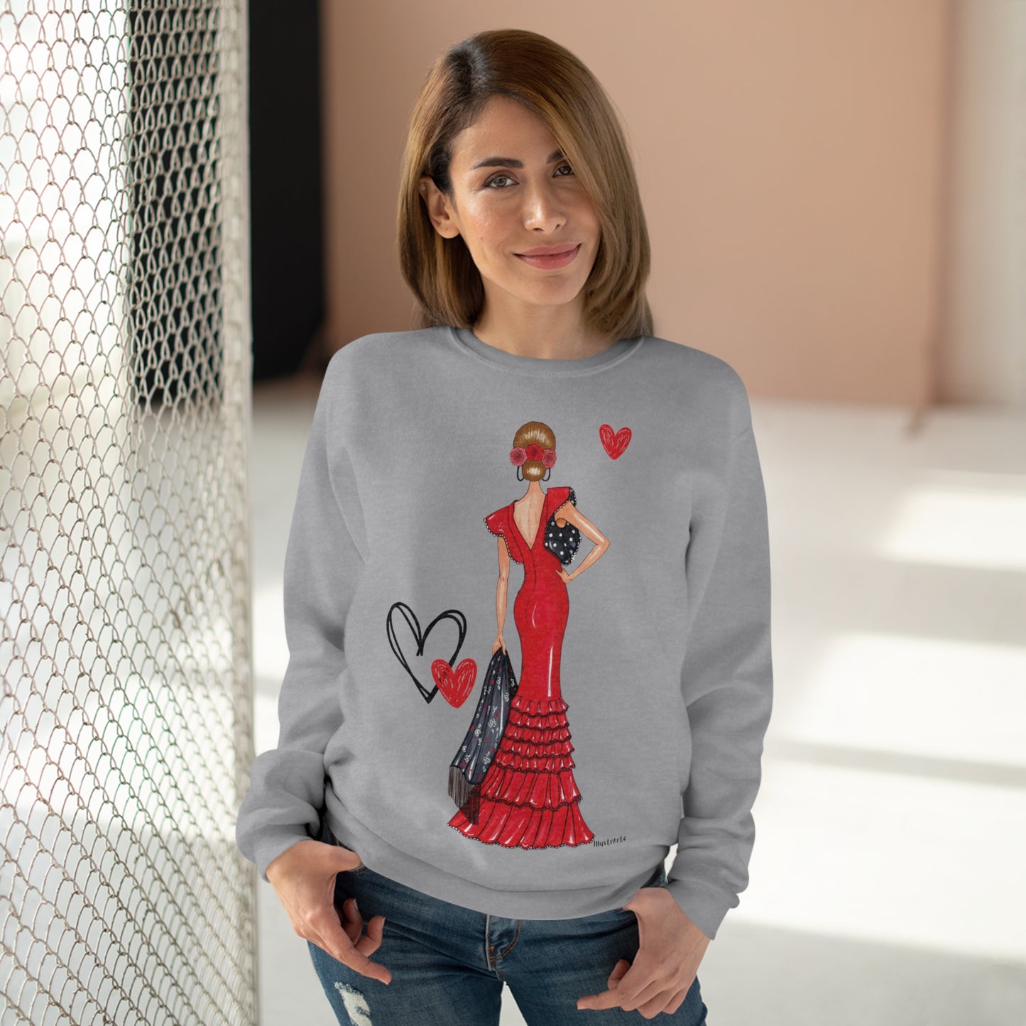 a woman wearing a sweater with a picture of a woman in a red dress