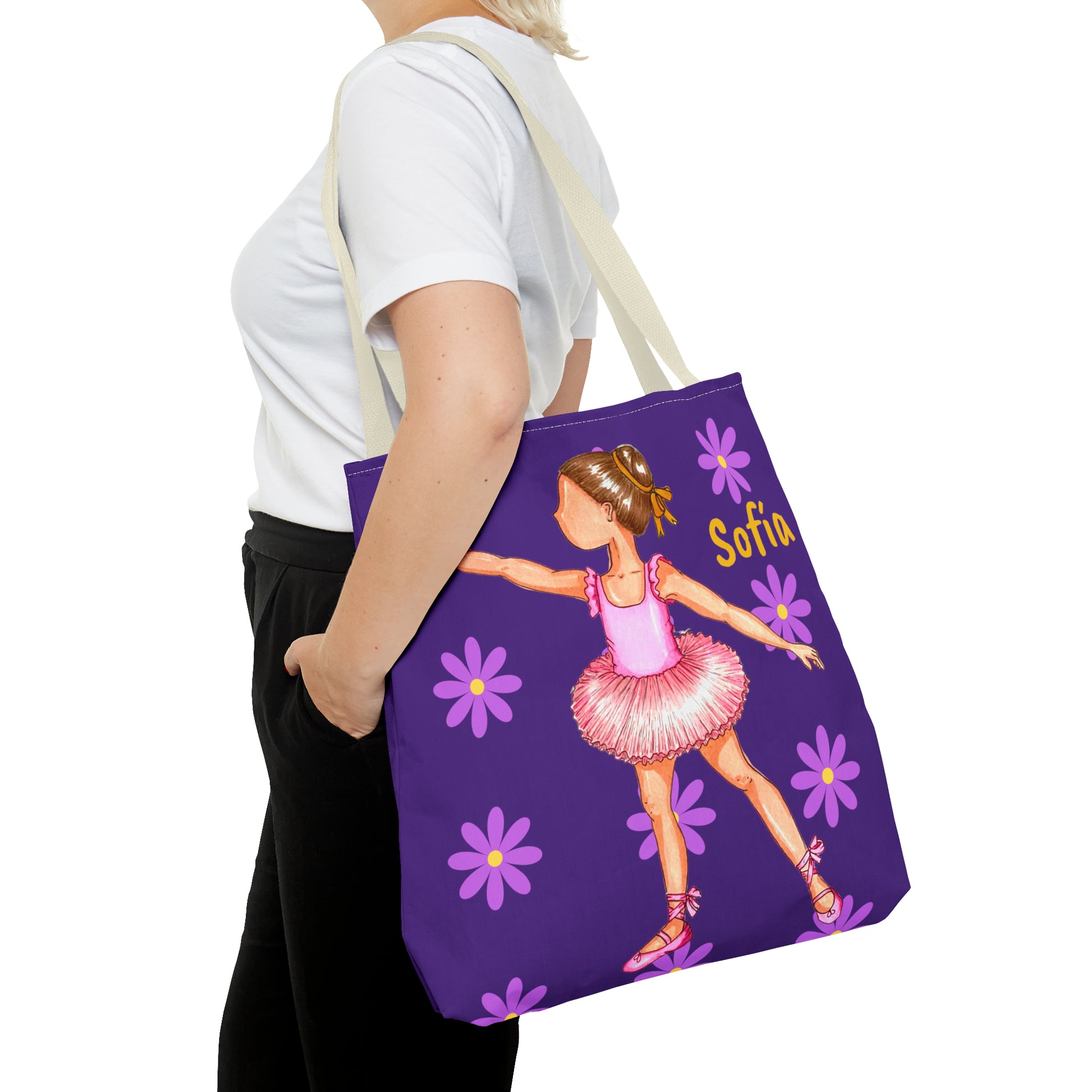 a woman carrying a purple tote bag with a picture of a ballerina