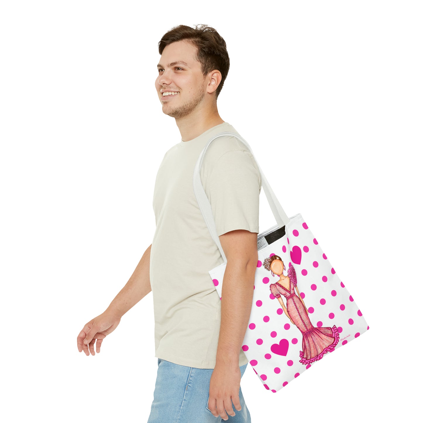 a man carrying a pink and white polka dot bag