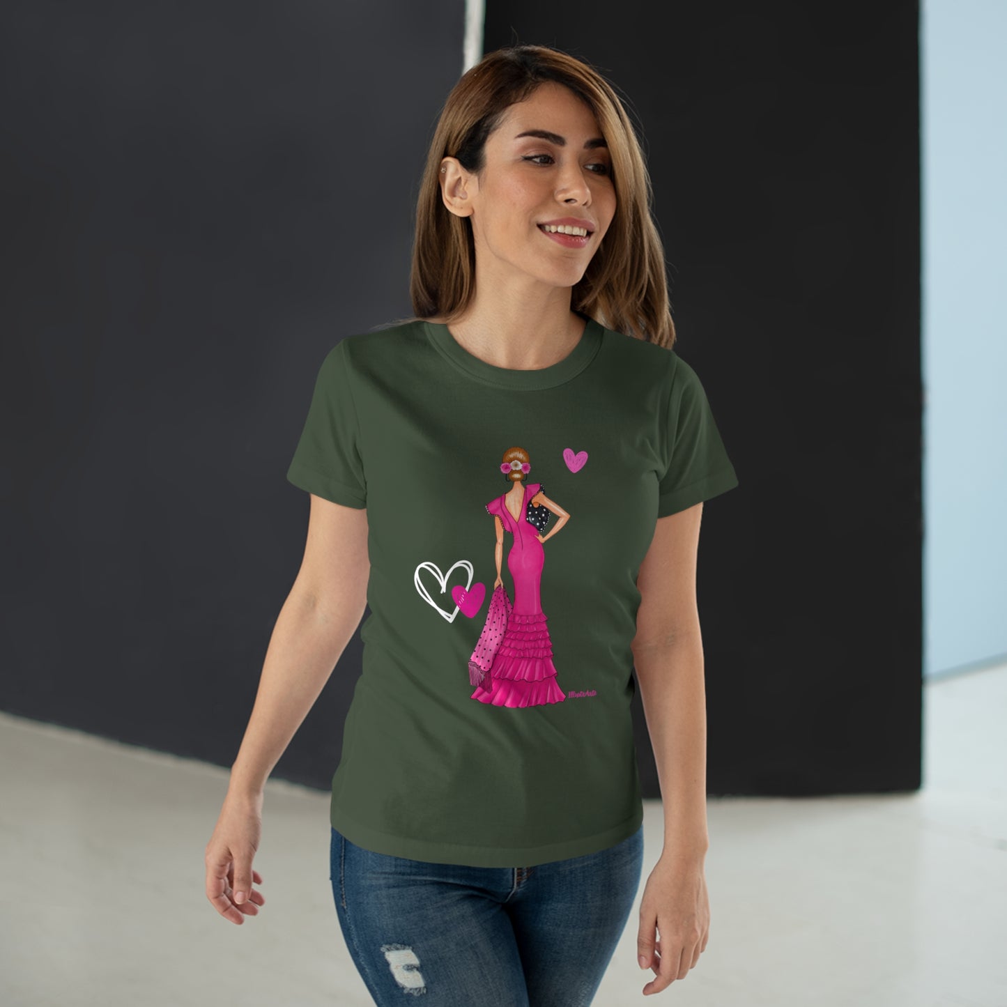 a woman wearing a green t - shirt with a pink dress