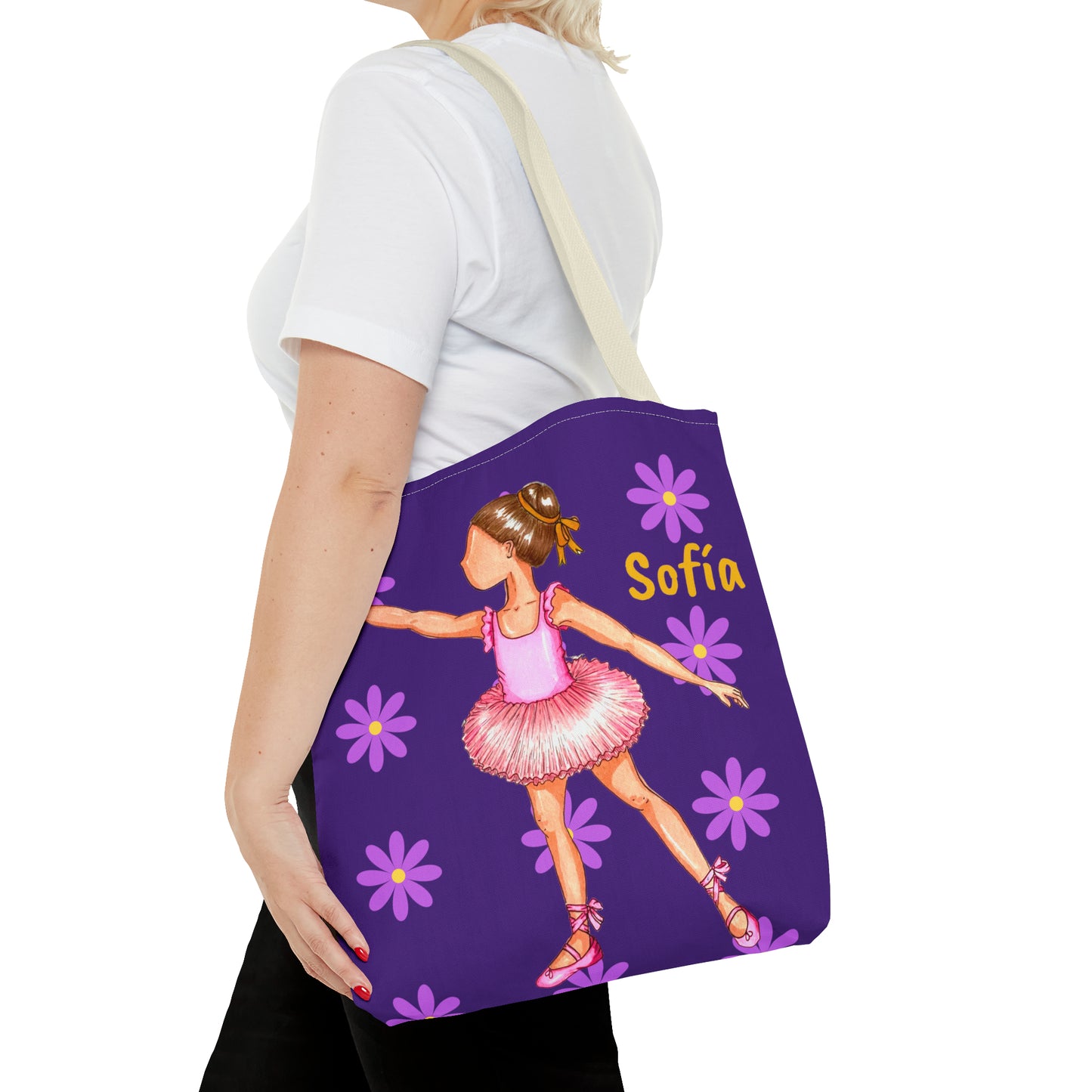 a woman carrying a purple tote bag with a picture of a ballerina