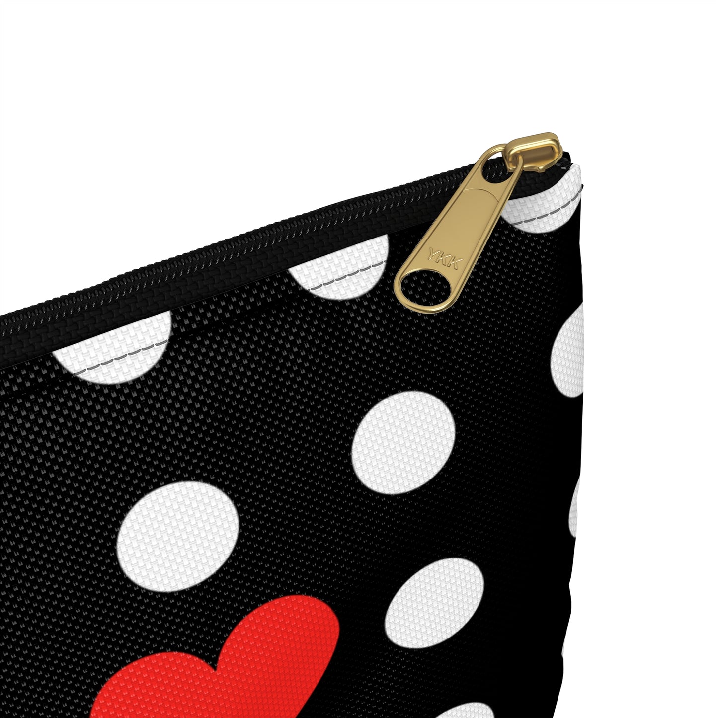 a black and white polka dot purse with a red heart on it