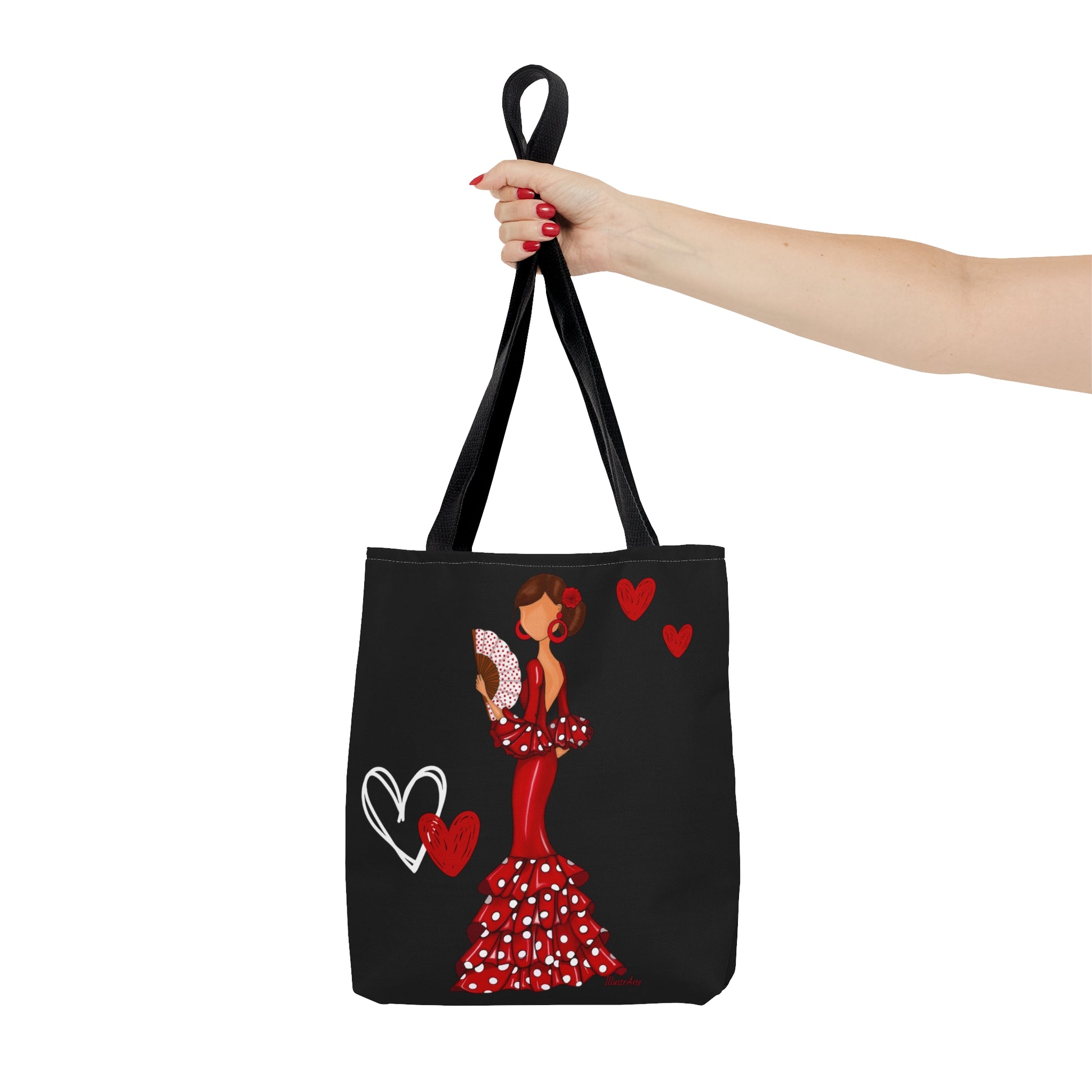 a woman's hand holding a tote bag with a picture of a woman