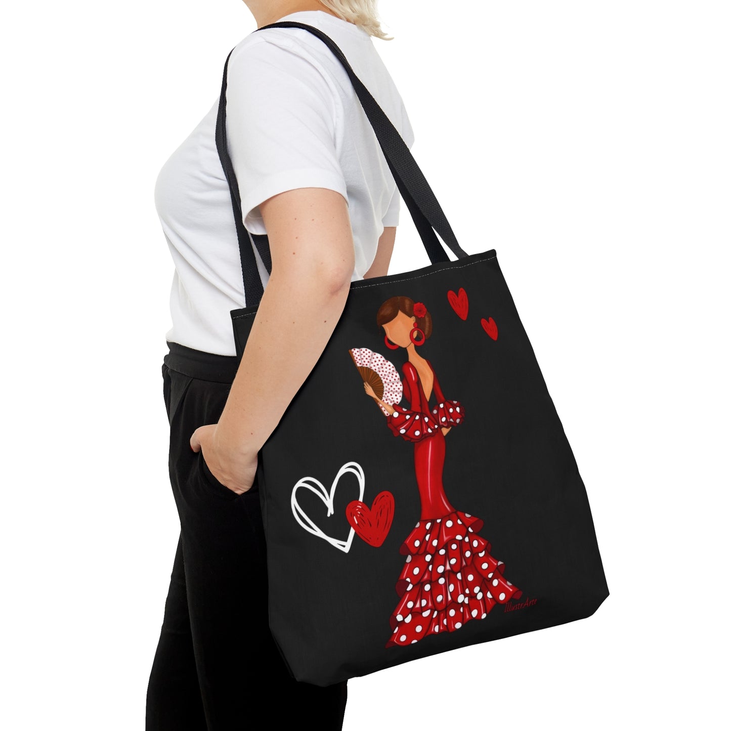 a woman carrying a black tote bag with a picture of a woman in a