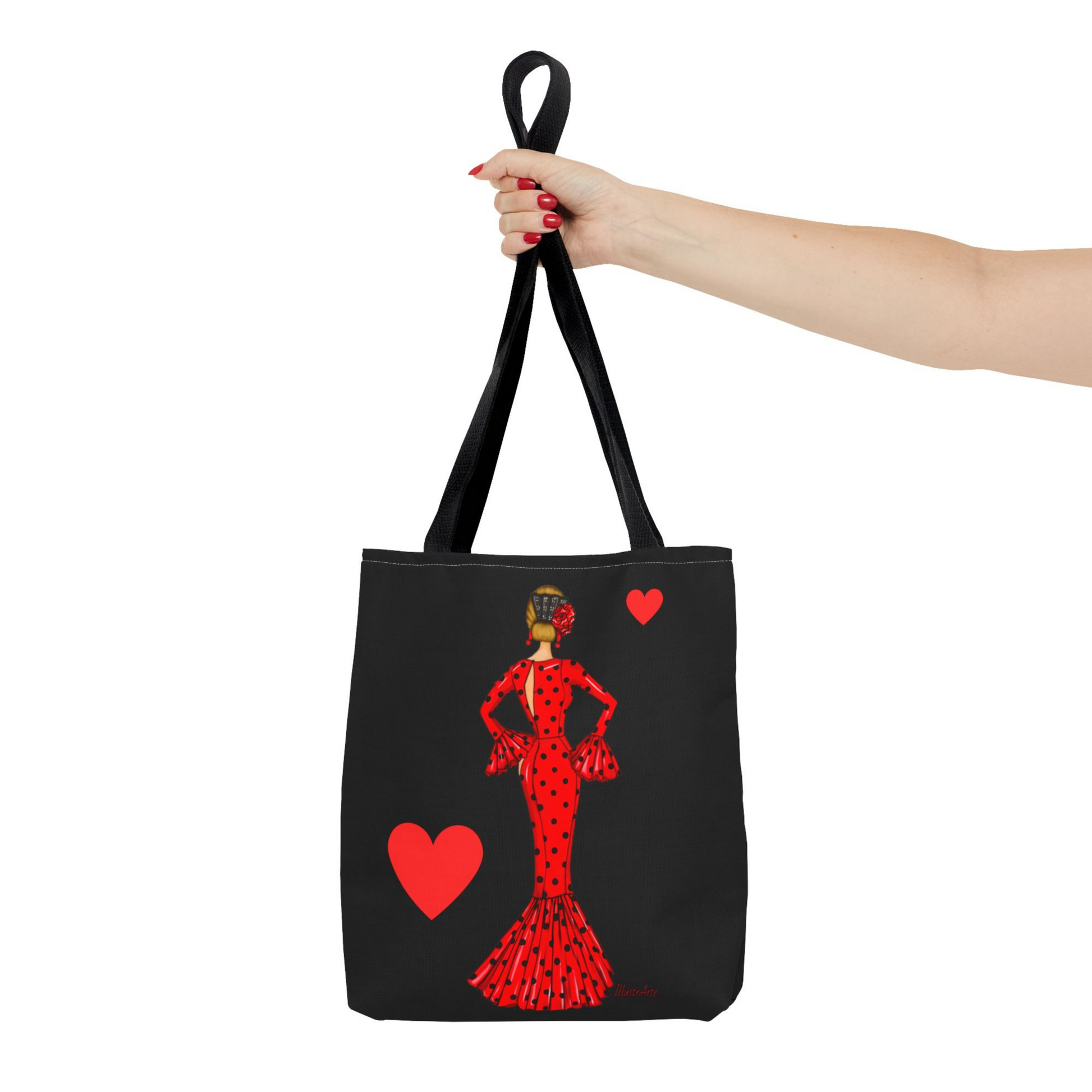 a woman's hand holding a tote bag with a picture of a woman