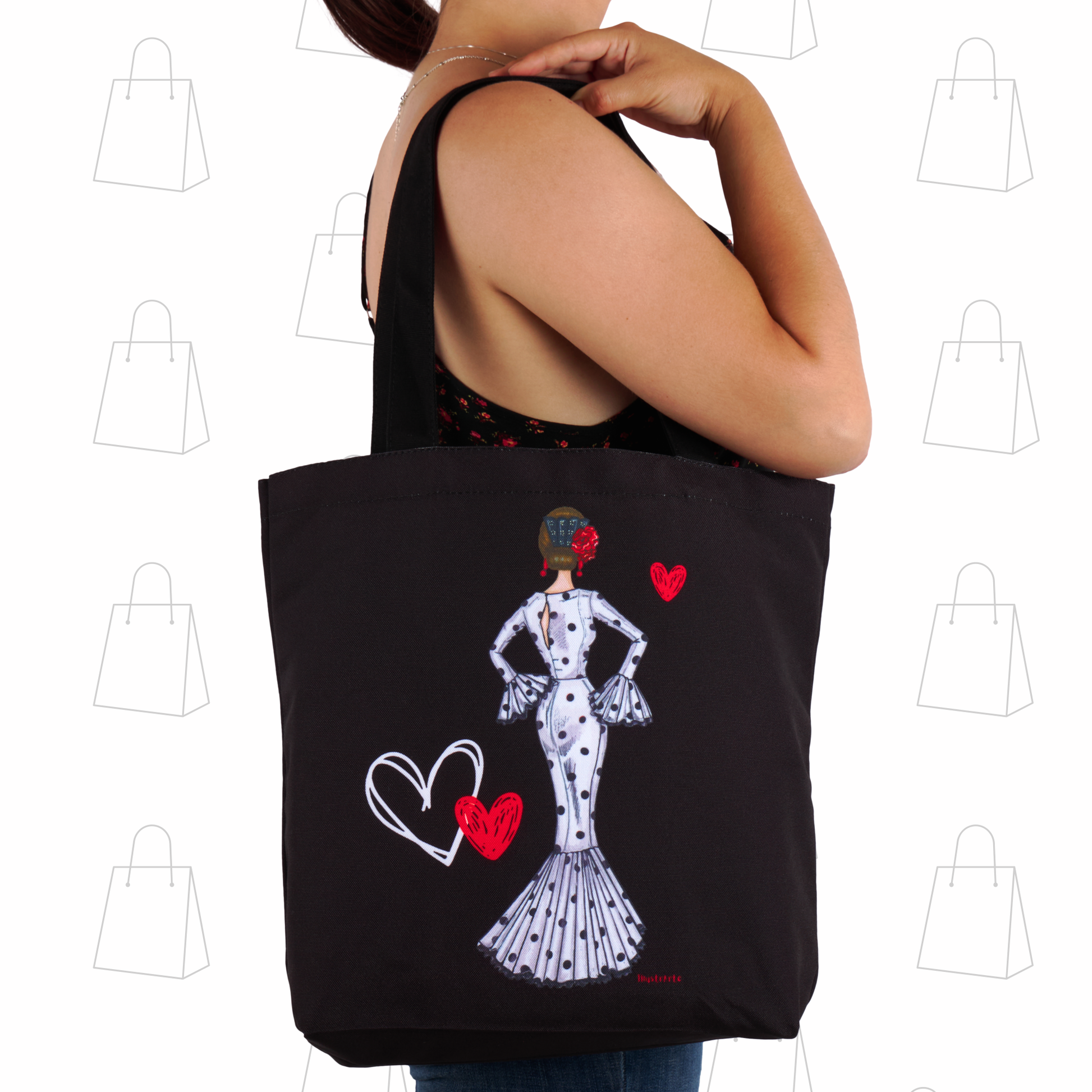 a woman holding a black tote bag with a picture of a woman in a