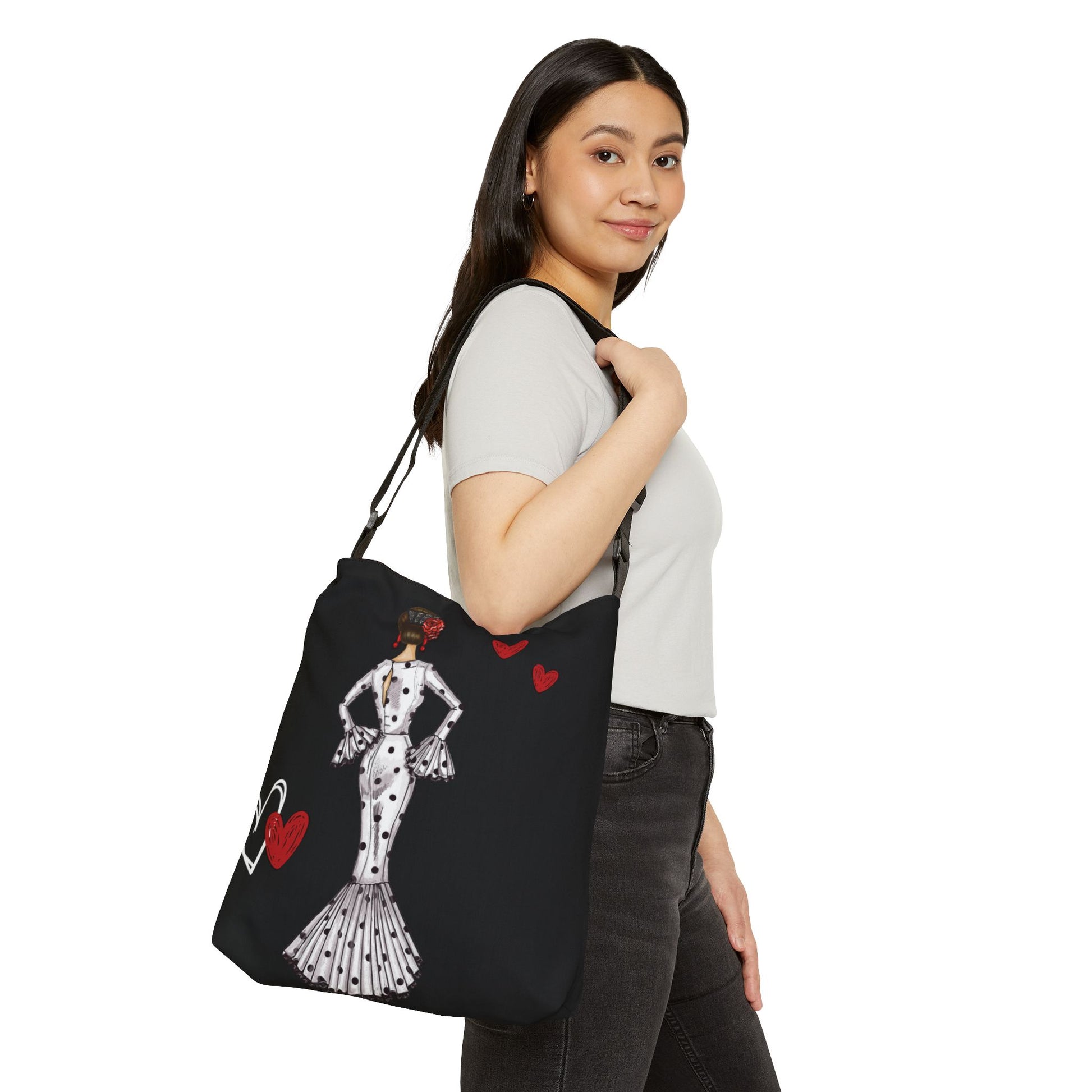 a woman carrying a black bag with a picture of a woman on it