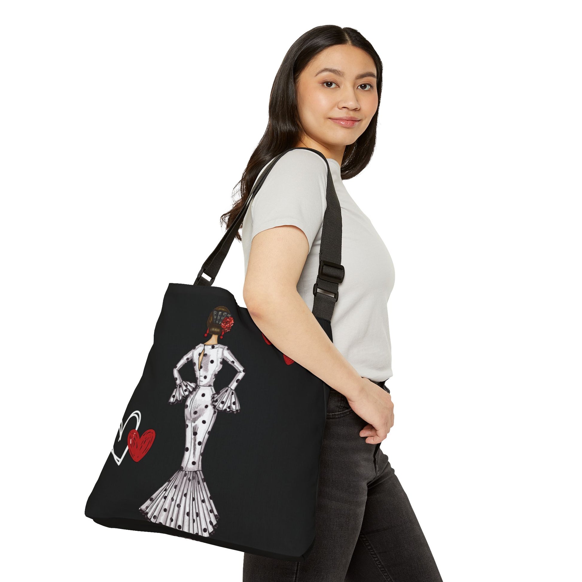 a woman carrying a black bag with a picture of a woman on it