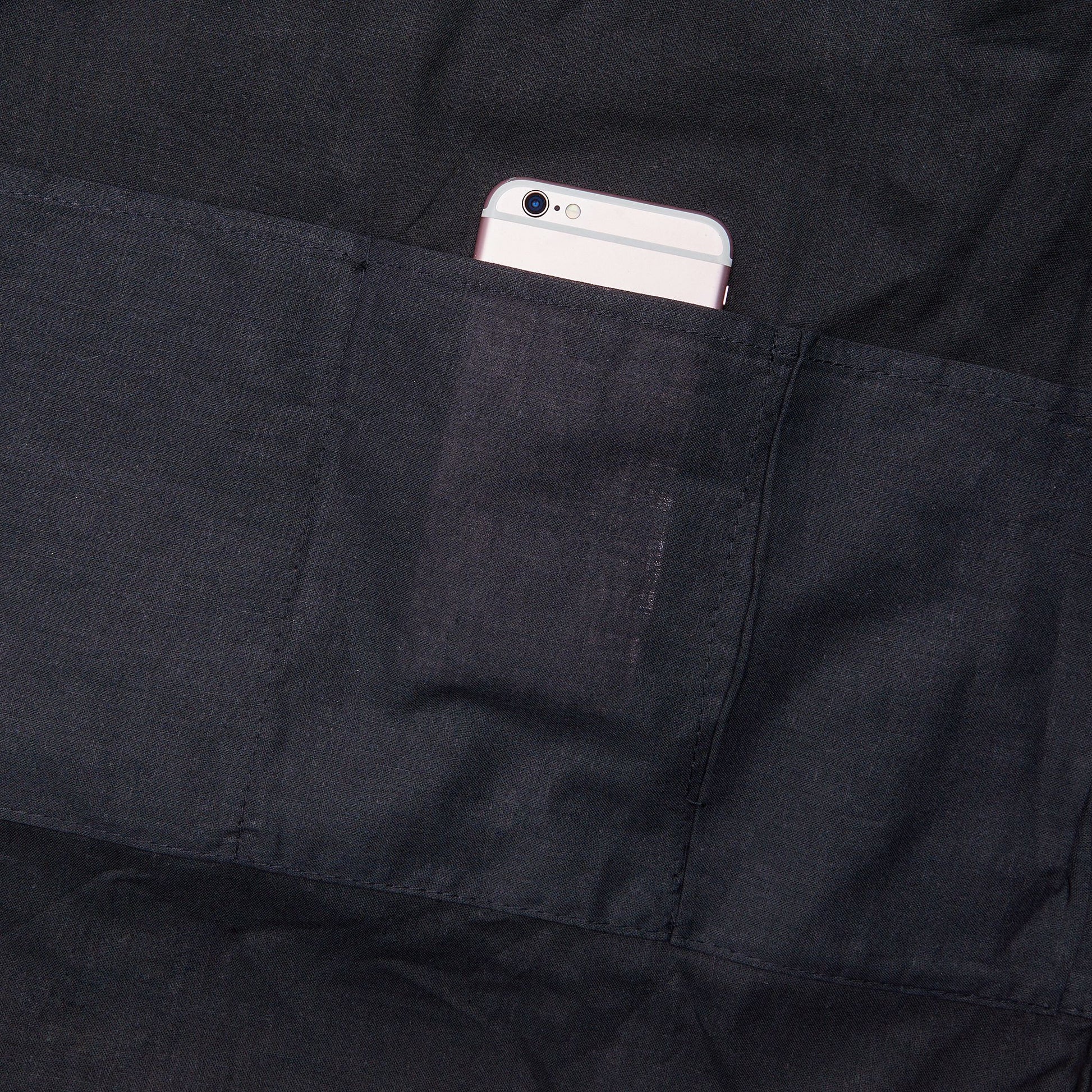 a cell phone in the pocket of a black jacket