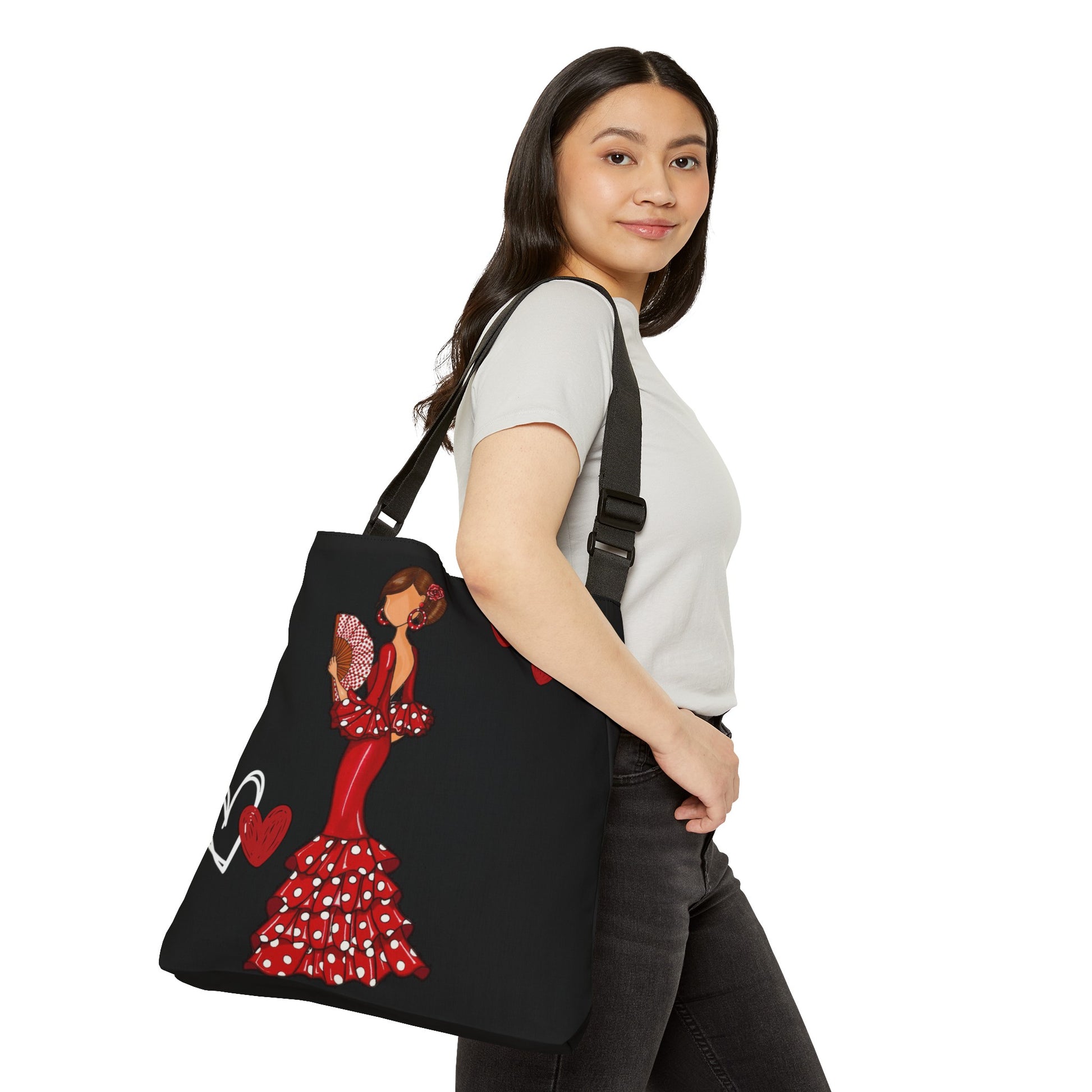 a woman carrying a black bag with a picture of a woman in a red dress