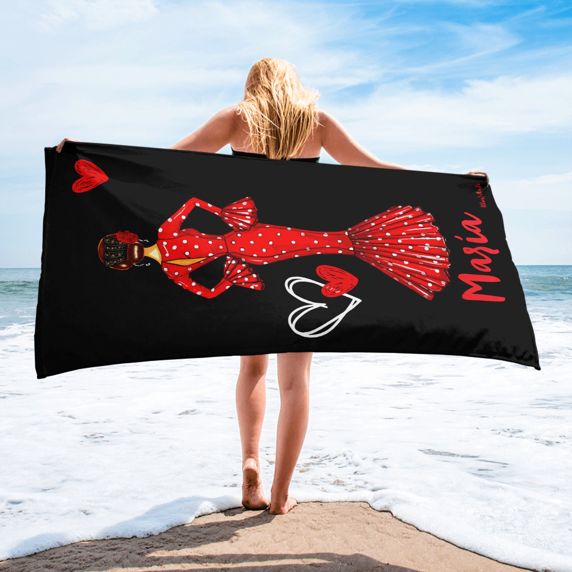 a woman standing on a beach holding a towel