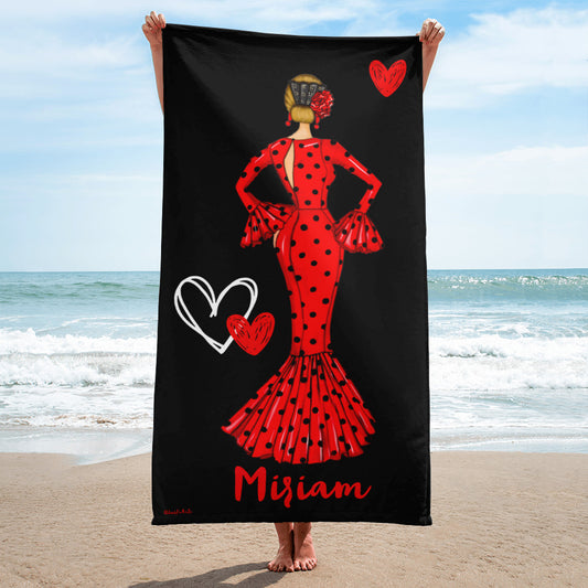 a woman in a red dress holding a black beach towel