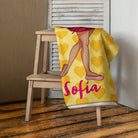 a yellow blanket with a picture of a woman on it