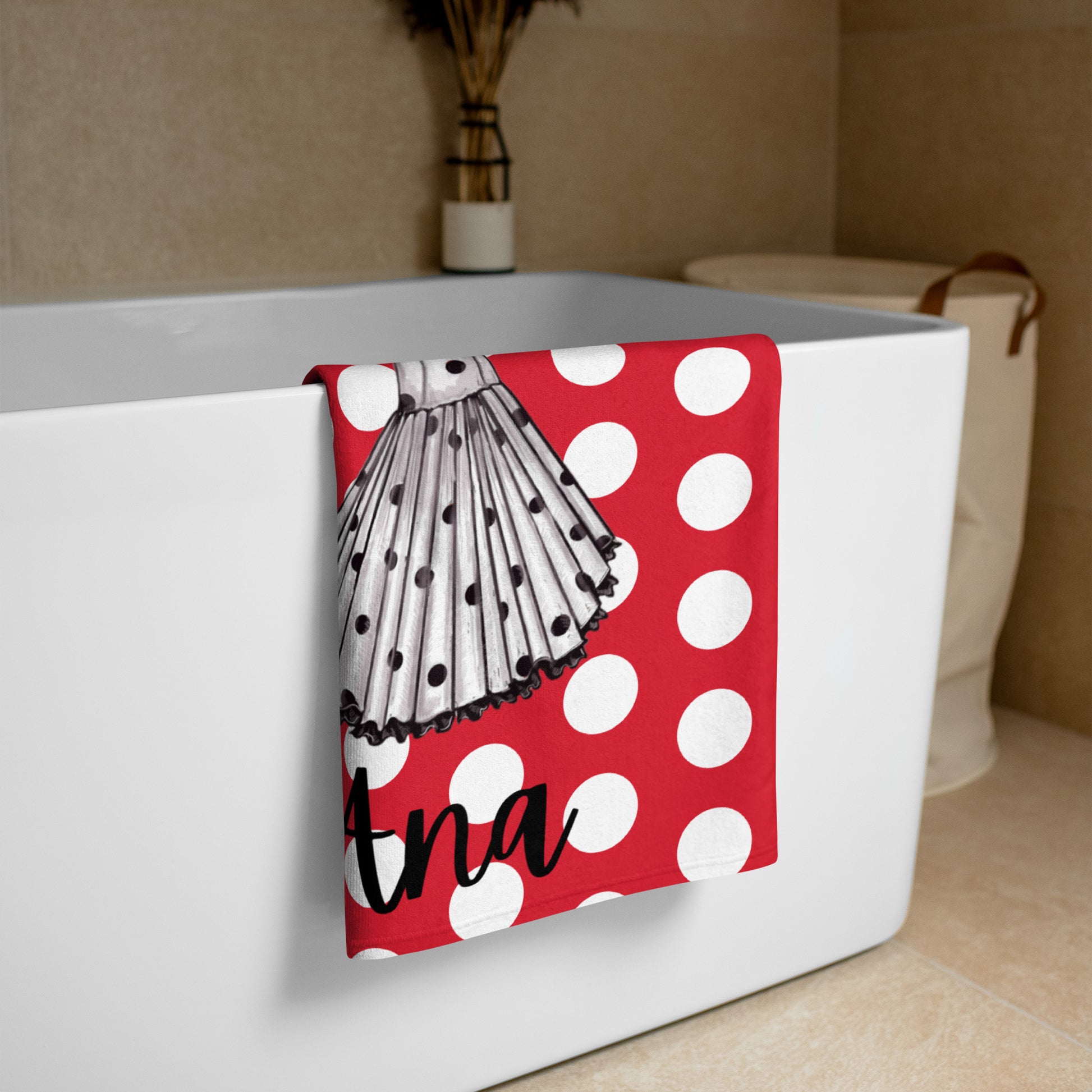 a bath tub with a red and white towel hanging from it's side