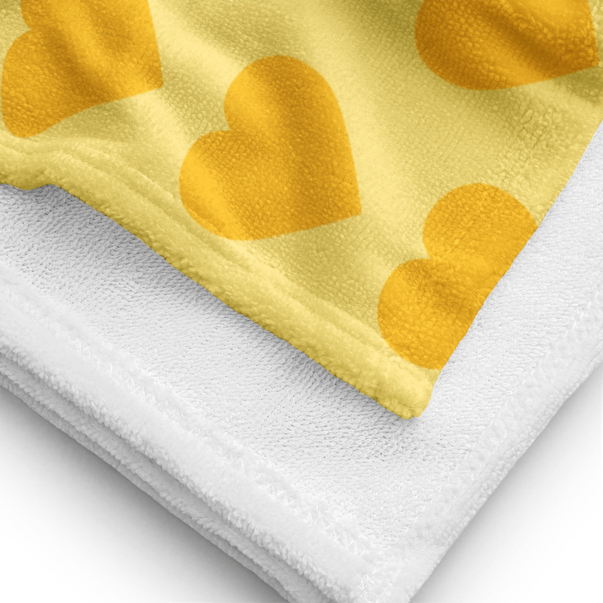 a yellow and white towel with hearts on it